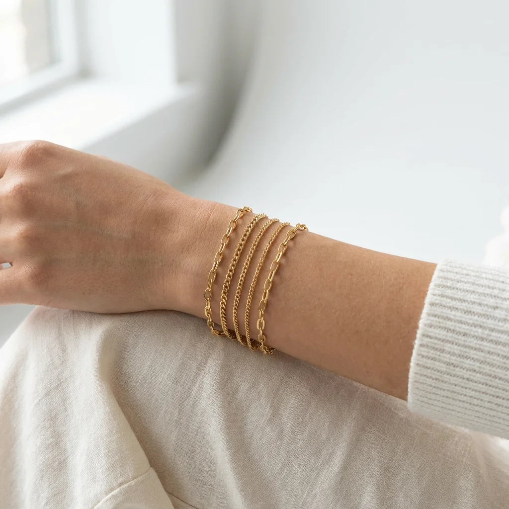 Lifestyle shot - stacked gold bracelets